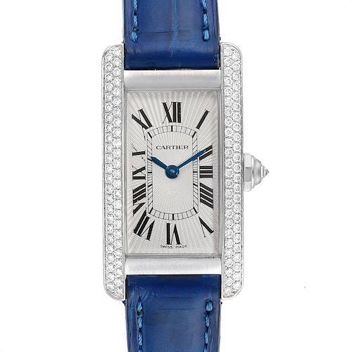 The image shows a front view of a Cartier Tank Américaine watch, featuring a rectangular face, blue hands, and a blue leather strap.