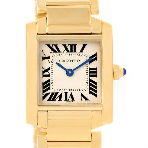 This image shows the face and part of the gold bracelet of the Cartier Tank Francaise W50002N2 Women's Yellow Gold Silver Dial W50002N2 Women's Yellow Gold Silver Dial watch, displaying Roman numerals and blue hands.