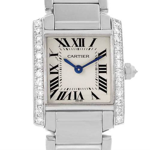 The image shows a close-up of the Cartier Tank Francaise WE1002S3 Women's White Gold Silver Dial WE1002S3 Women's White Gold Silver Dial watch, highlighting its face, Roman numerals, and bejeweled case sides.