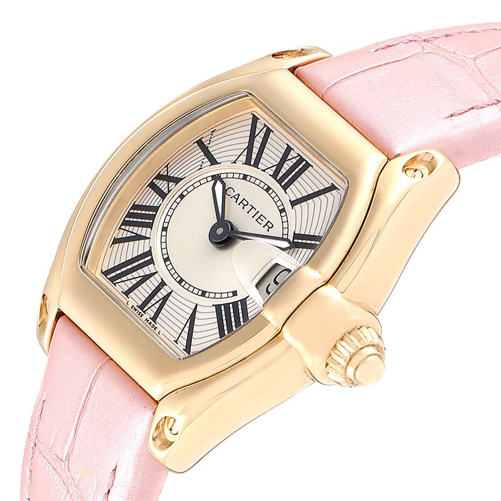This is a close-up of a Cartier Roadster W62018Y5 Women's Yellow Gold Silver Dial W62018Y5 Women's Yellow Gold Silver Dial watch showcasing its dial, case, crown, and pink leather strap from an angled side view.