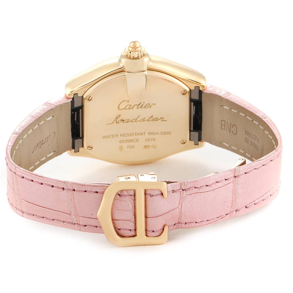 This Cartier Roadster W62018Y5 Women's Yellow Gold Silver Dial W62018Y5 Women's Yellow Gold Silver Dial watch is shown from the back, highlighting its case, engraving, and pink leather strap with a clasp.