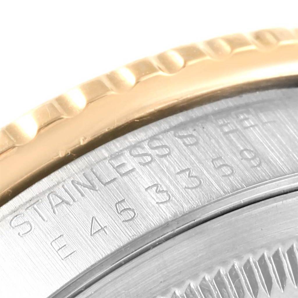Close-up of the edge of a Rolex Turn-o-Graph 16263 Men's Steel and Gold (two tone) Beige Dial 16263 Men's Steel and Gold (two tone) Beige Dial showing part of the bezel and engraved serial number.