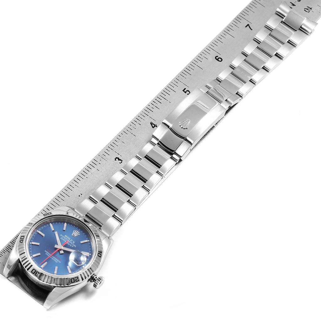 The Rolex Turn-o-Graph 116264 Men's Stainless Steel Blue Dial 116264 Men's Stainless Steel Blue Dial model watch is shown from a top view, displaying the face, bezel, bracelet, and clasp alongside a ruler.