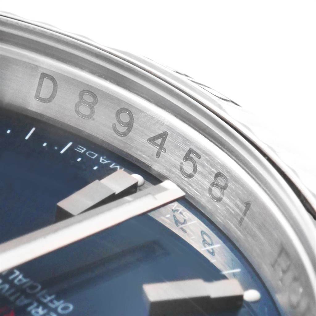The image shows a close-up of the serial number and part of the face of a Rolex Turn-o-Graph 116264 Men's Stainless Steel Blue Dial 116264 Men's Stainless Steel Blue Dial watch.