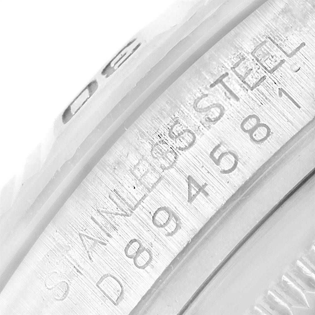 This close-up image shows the serial number and stainless steel engraving on a Rolex Turn-o-Graph 116264 Men's Stainless Steel Blue Dial 116264 Men's Stainless Steel Blue Dial watch.