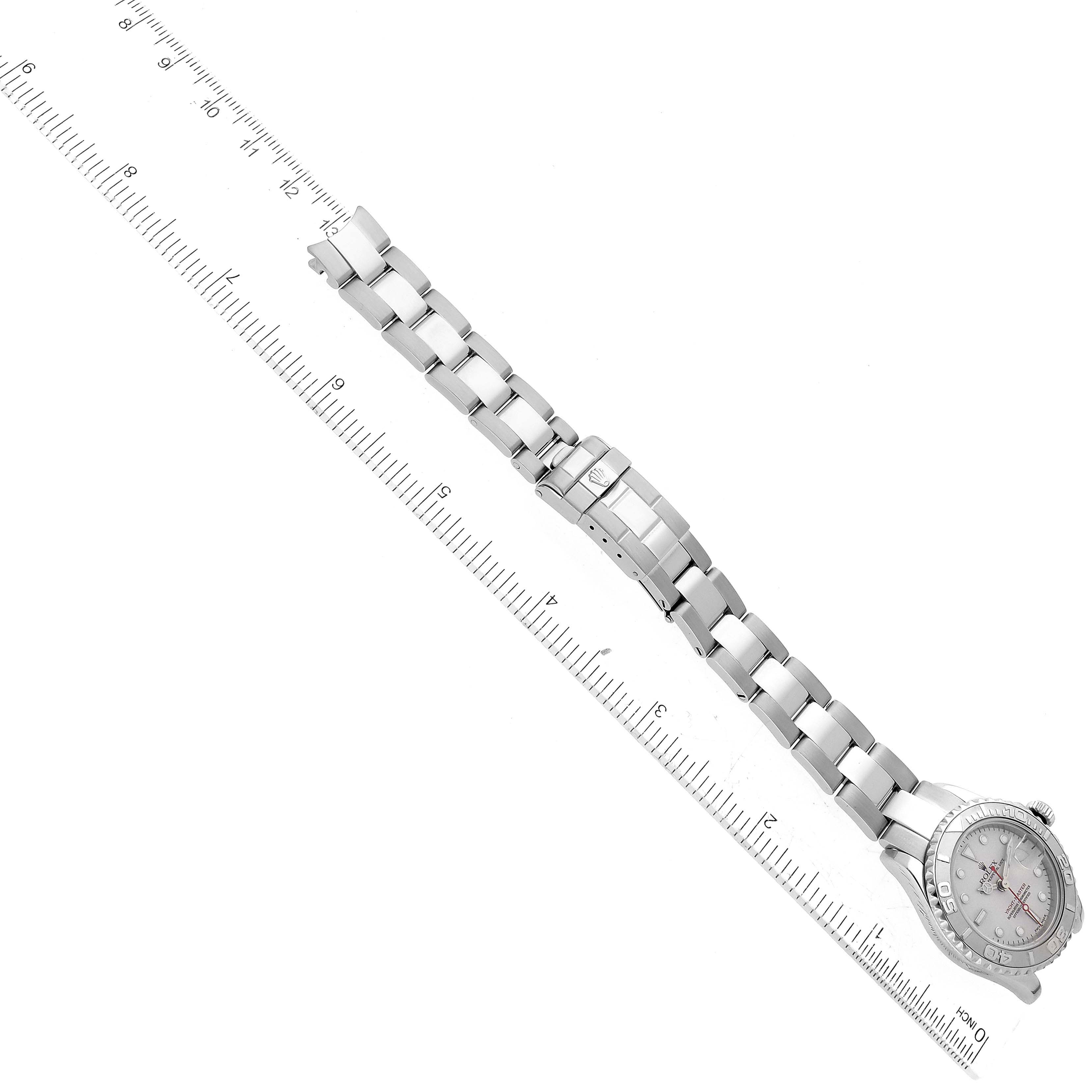 The Rolex Yacht-Master 169622 Women's Stainless Steel Silver Dial 169622 Women's Stainless Steel Silver Dial watch is pictured at an angle, showing the face, bezel, and full metal bracelet alongside a ruler for scale.