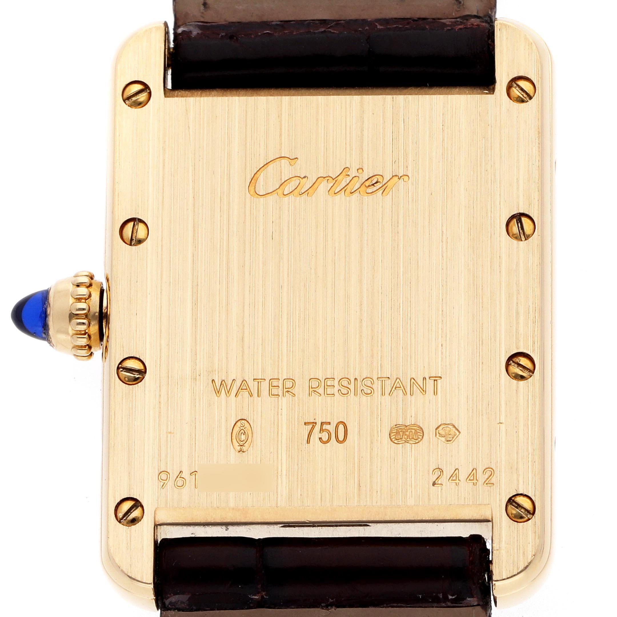 The image shows the back of a Cartier Tank Louis W1529856 Women's Yellow Gold Silver Dial W1529856 Women's Yellow Gold Silver Dial watch, highlighting its branded engravings and a sapphire cabochon crown.