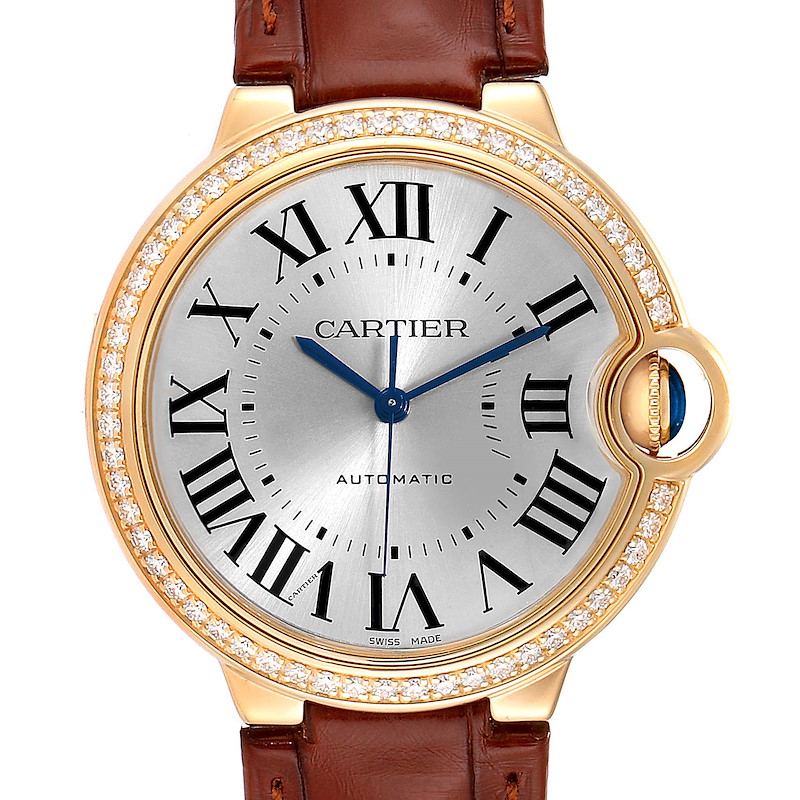 This image shows a front view of the Cartier Ballon Bleu WE900451 Women's Yellow Gold Silver Dial WE900451 Women's Yellow Gold Silver Dial watch, highlighting its Roman numerals, diamond bezel, leather strap, and blue hands.