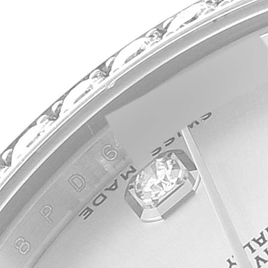 The image shows a close-up angle of a Rolex Mid-Size 178384 Women's Stainless Steel Silver Dial 178384 Women's Stainless Steel Silver Dial model watch focusing on a diamond marker and part of the bezel.