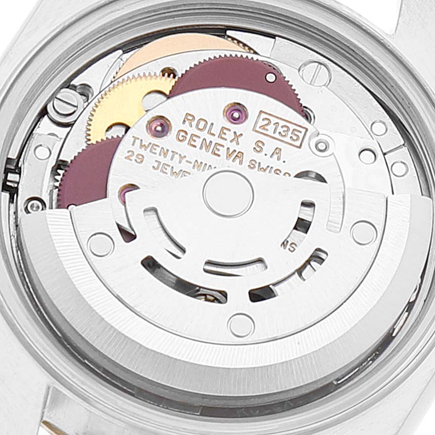 The image shows a close-up of the Rolex Datejust 69173 Women's Steel and Gold (two tone) White Dial 69173 Women's Steel and Gold (two tone) White Dial watch movement, featuring gears and the oscillating weight.