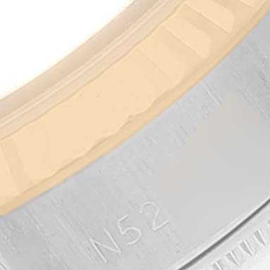 The image shows a close-up of the bezel and part of the case of a Rolex Datejust 69173 Women's Steel and Gold (two tone) White Dial 69173 Women's Steel and Gold (two tone) White Dial watch.