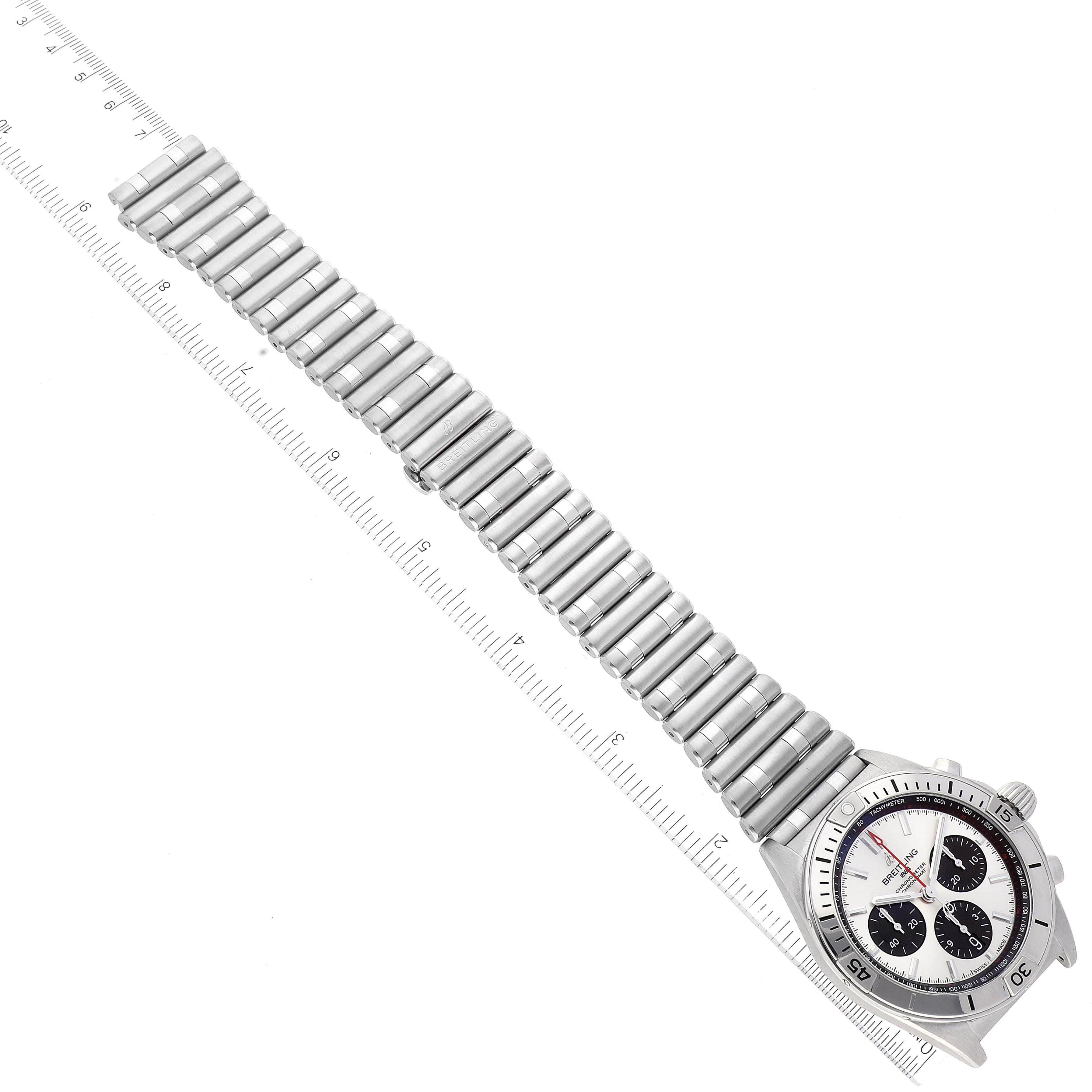 The Breitling Chronomat AB0134 Men's Stainless Steel Silver Dial AB0134 Men's Stainless Steel Silver Dial watch is shown from an overhead angle, displaying its full bracelet and bezel with a measuring ruler next to it.