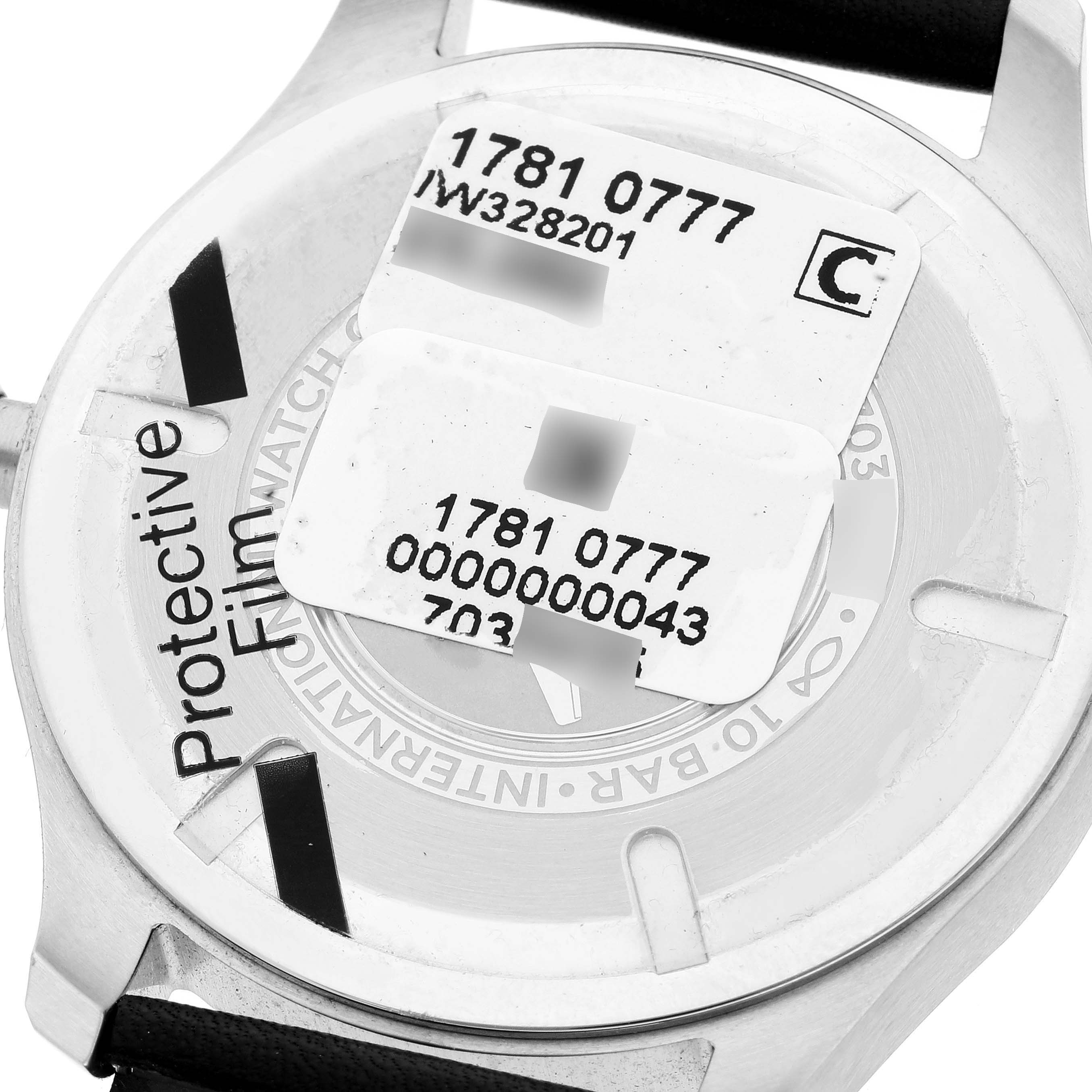 This image shows the back of an IWC Pilot IW328201 Men's Stainless Steel Black Dial IW328201 Men's Stainless Steel Black Dial model watch with protective film and serial number labels.