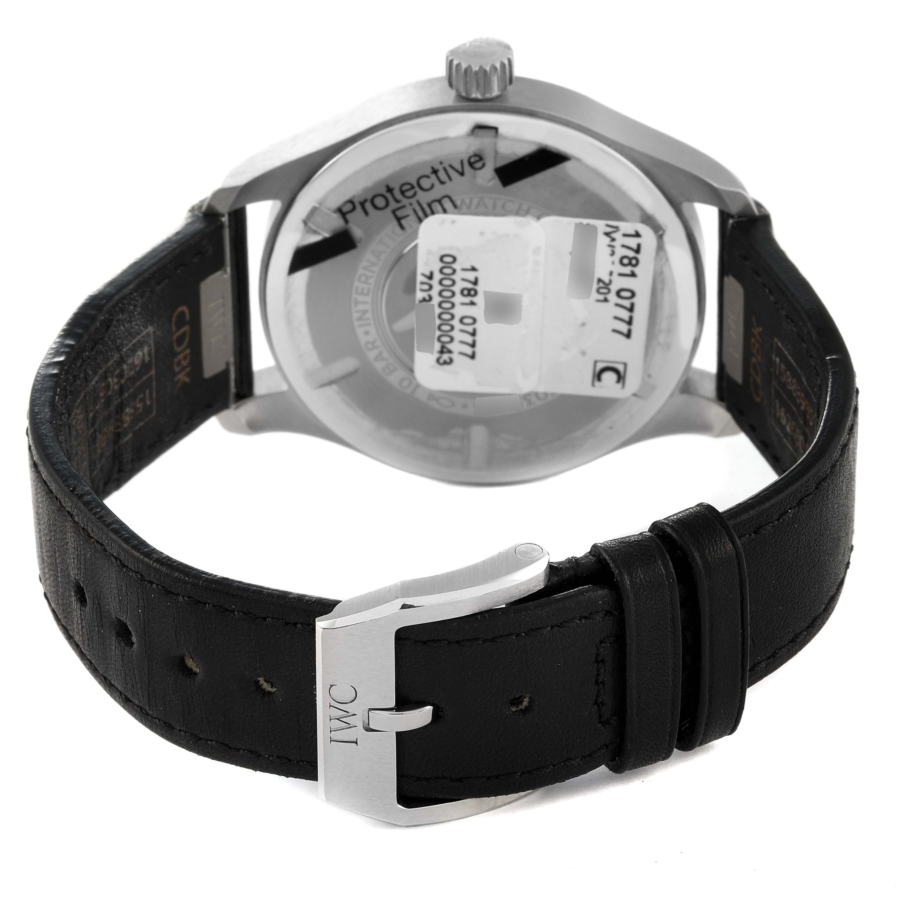 The image shows the back view of the IWC Pilot IW328201 Men's Stainless Steel Black Dial IW328201 Men's Stainless Steel Black Dial watch, highlighting its buckle, leather strap, and case back with protective film.