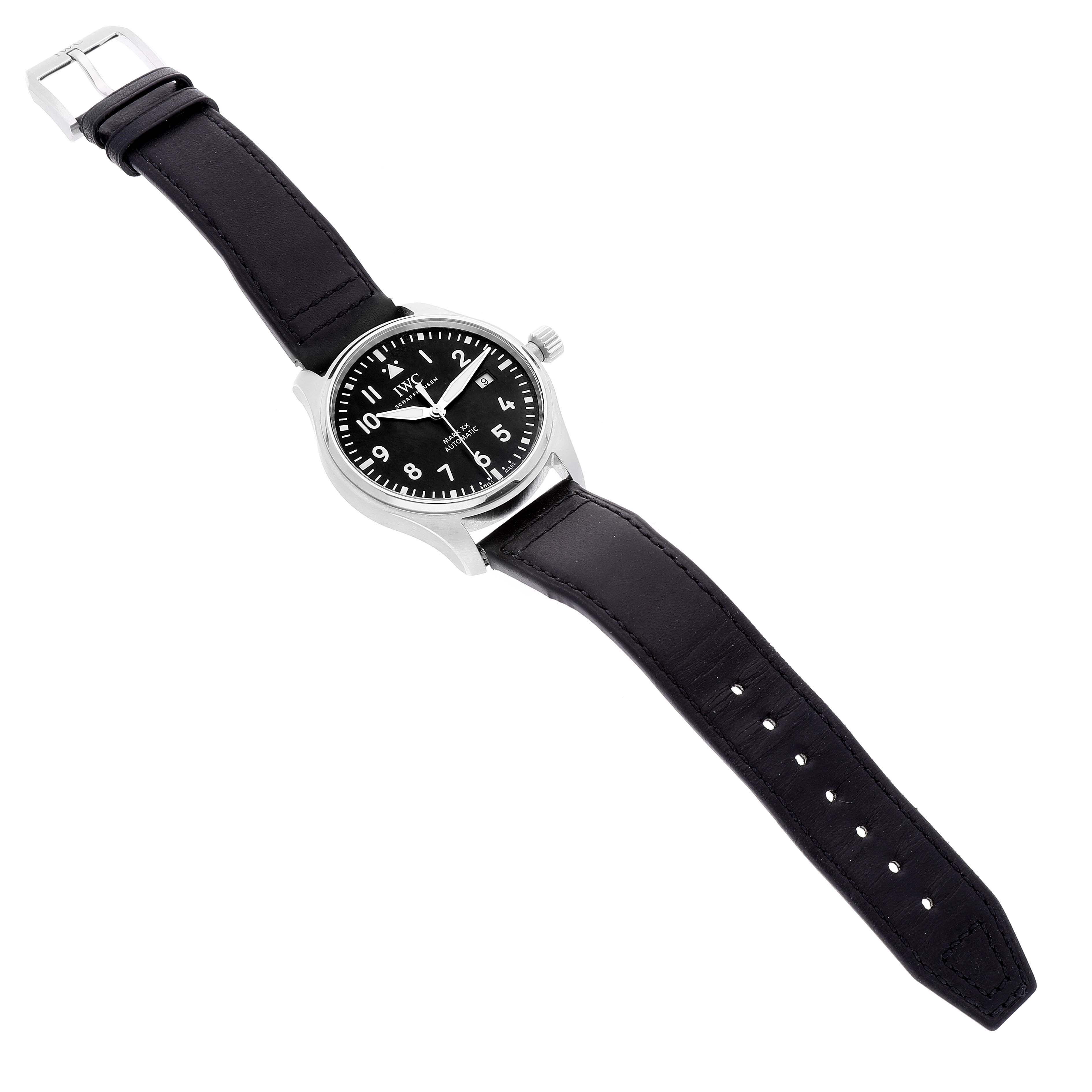 The image shows an IWC Pilot IW328201 Men's Stainless Steel Black Dial IW328201 Men's Stainless Steel Black Dial model wristwatch from a top-down angle, highlighting its black dial, stainless steel case, and black leather strap.
