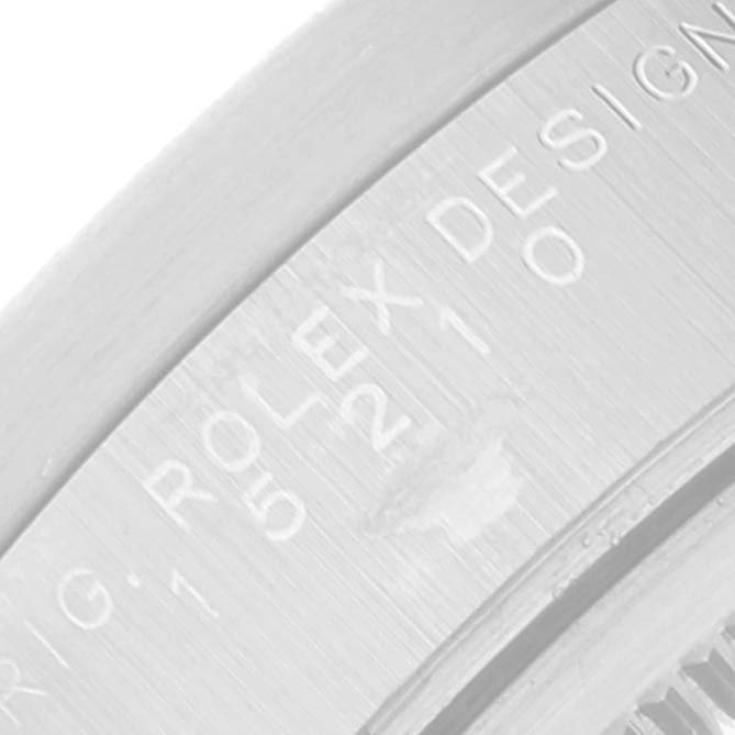 The image shows a close-up angle of the engraved lettering on the side of a Rolex Date 15210 Men's Stainless Steel Pink Dial 15210 Men's Stainless Steel Pink Dial model watch's case.