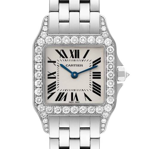 The image shows a frontal view of a Santos Demoiselle watch by Cartier, highlighting the watch face, bezel, and part of the bracelet.