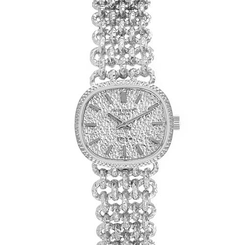 The Patek Philippe Golden Ellipse 4133 Women's White Gold White Dial 4133 Women's White Gold White Dial watch is shown from the front, highlighting its textured dial and intricate metal bracelet.