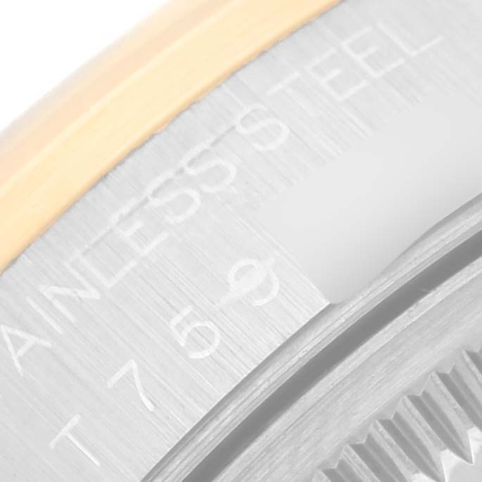 This image shows a close-up angle of the side engraving on a Rolex Date 15203 Men's Steel and Gold (two tone) Blue Dial 15203 Men's Steel and Gold (two tone) Blue Dial model watch, highlighting details like the "STAINLESS STEEL" marking.