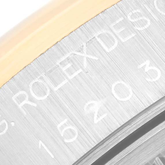 This close-up image shows part of the case back engraving on a Rolex Date 15203 Men's Steel and Gold (two tone) Blue Dial 15203 Men's Steel and Gold (two tone) Blue Dial model watch.