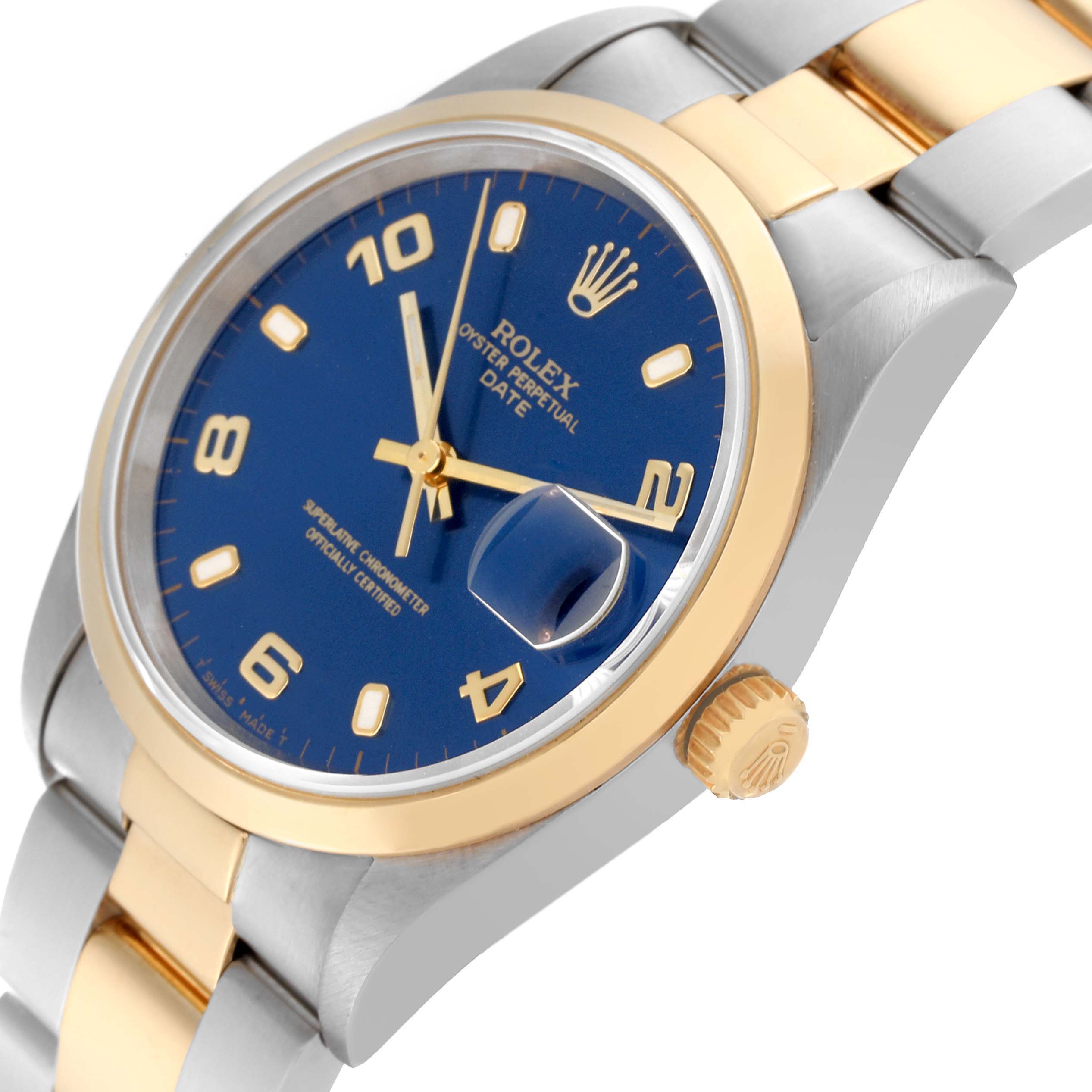 The image shows a Rolex Date 15203 Men's Steel and Gold (two tone) Blue Dial 15203 Men's Steel and Gold (two tone) Blue Dial model watch at an angle highlighting the blue dial, gold bezel, crown, and part of the two-tone bracelet.