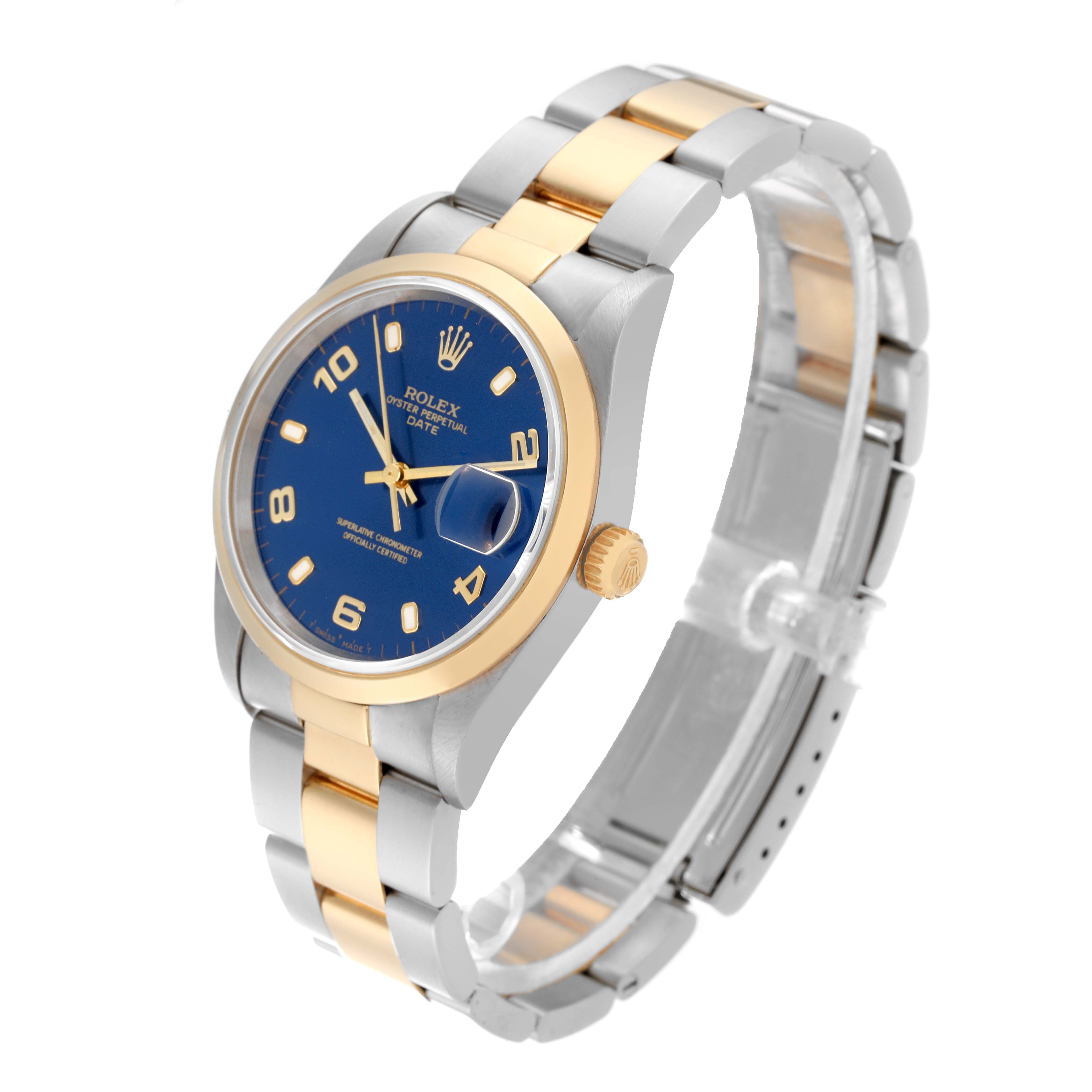 The image shows a Rolex Date 15203 Men's Steel and Gold (two tone) Blue Dial 15203 Men's Steel and Gold (two tone) Blue Dial model watch at a three-quarter angle, highlighting the blue dial, gold bezel, crown, and two-tone bracelet.