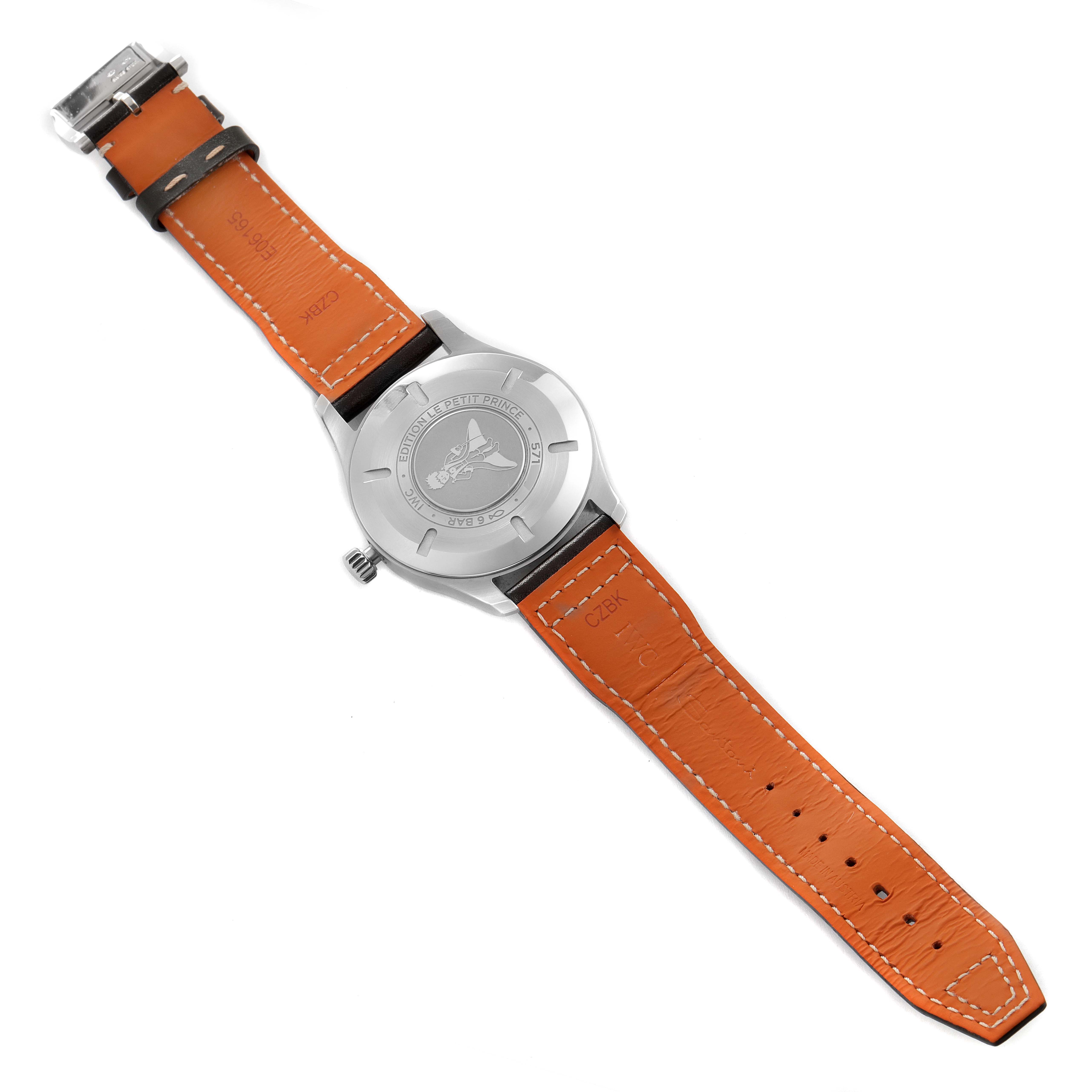 The image shows the back of an IWC Pilot IW327010 Men's Stainless Steel Blue Dial IW327010 Men's Stainless Steel Blue Dial model watch, highlighting the case back, crown, and orange strap.