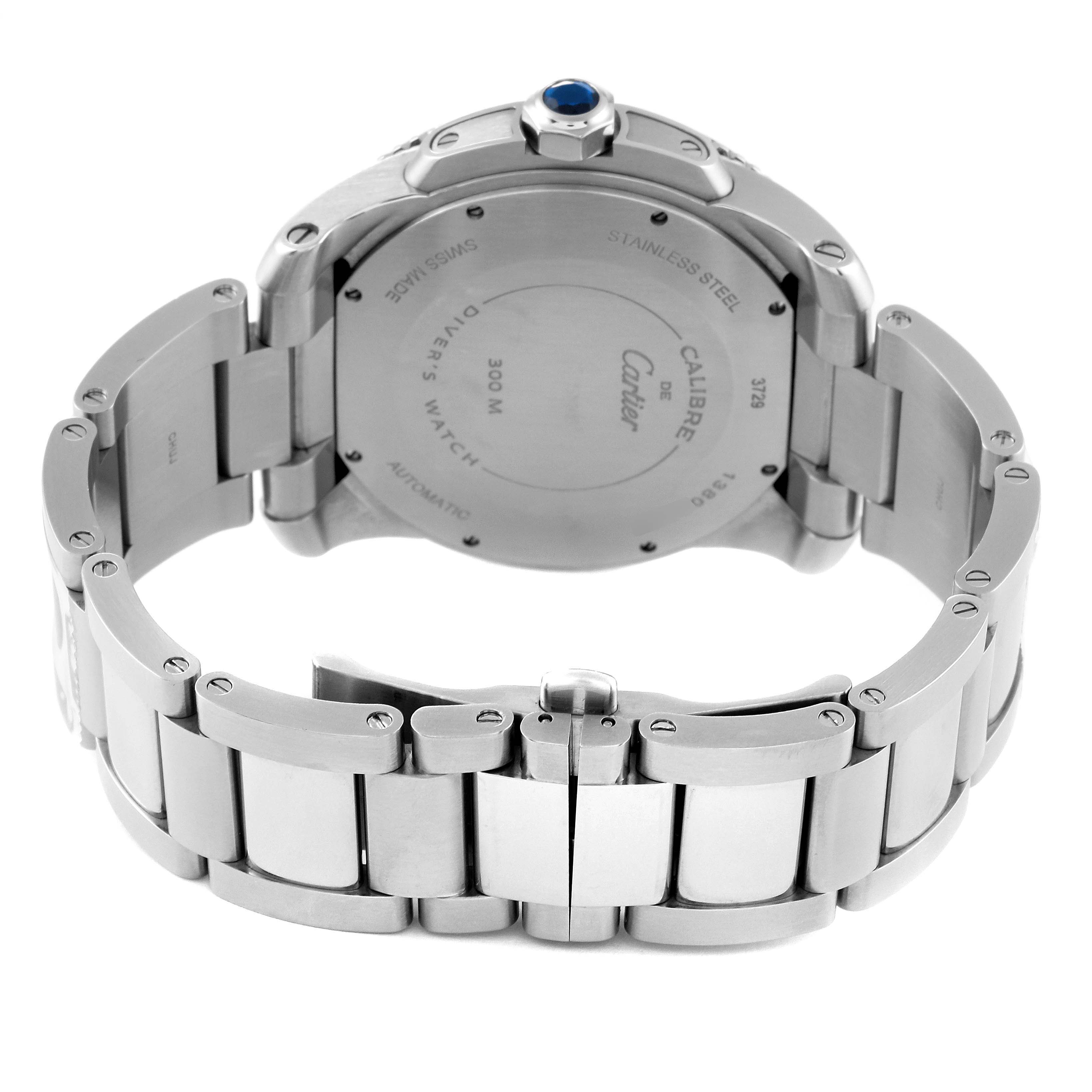 The image shows the back view of a Calibre de Cartier watch by Cartier, highlighting the case back and stainless steel bracelet.