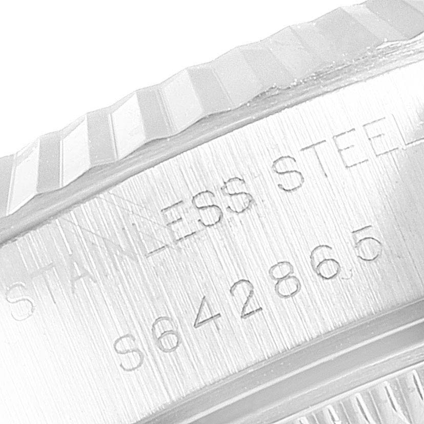 The image shows a close-up of the stainless steel bezel and serial number of a Rolex Datejust 69174 Women's Stainless Steel Black Dial 69174 Women's Stainless Steel Black Dial watch.