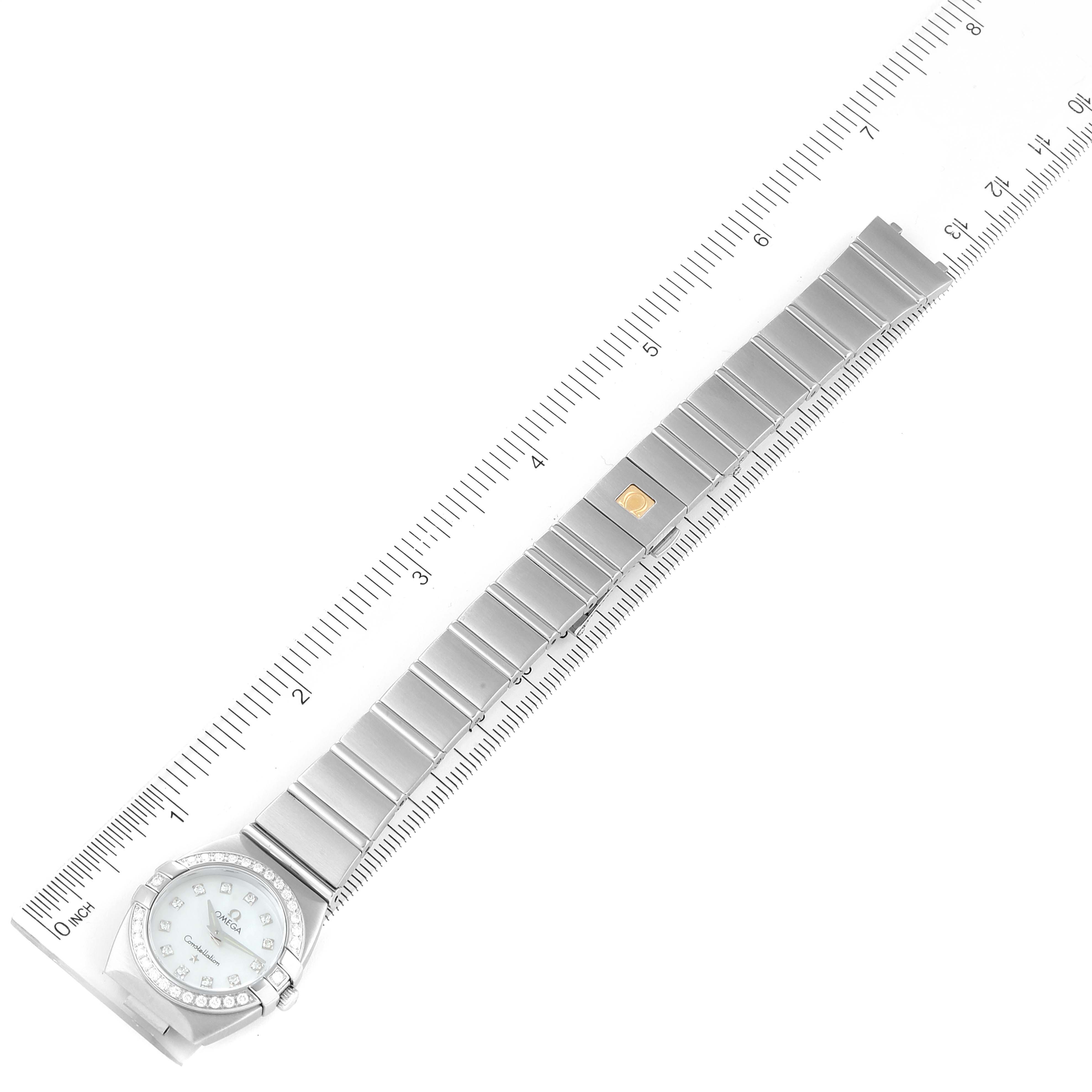 The Omega 123.15.24.60.57.001 Women's Stainless Steel Mother of Pearl Dial 123.15.24.60.57.001 Women's Stainless Steel Mother of Pearl Dial Constellation 24 MOP Diamond Ladies Watch 123.15.24.60.05.001 is shown flat, fully extended, with a ruler for scale.