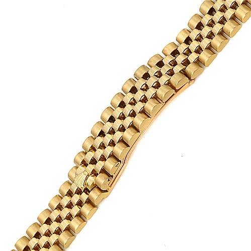 This image shows a close-up of the gold bracelet of a Rolex President 69178 Women's Yellow Gold Champagne Dial 69178 Women's Yellow Gold Champagne Dial model watch from a top-down angle.