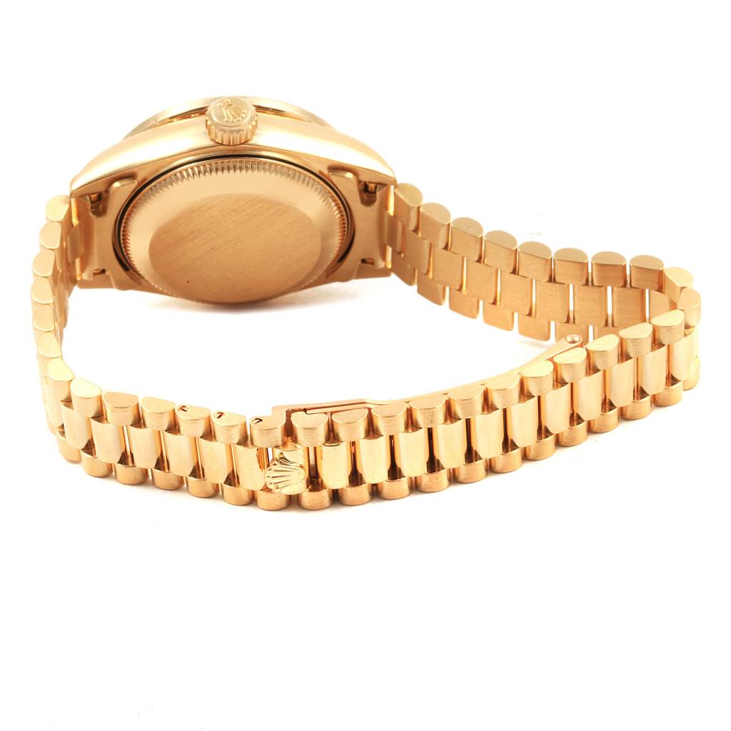 This image shows the back case, crown, and bracelet of a Rolex President 69138 Women's Yellow Gold Mother of Pearl Dial 69138 Women's Yellow Gold Mother of Pearl Dial model watch at a slight angle from the rear.