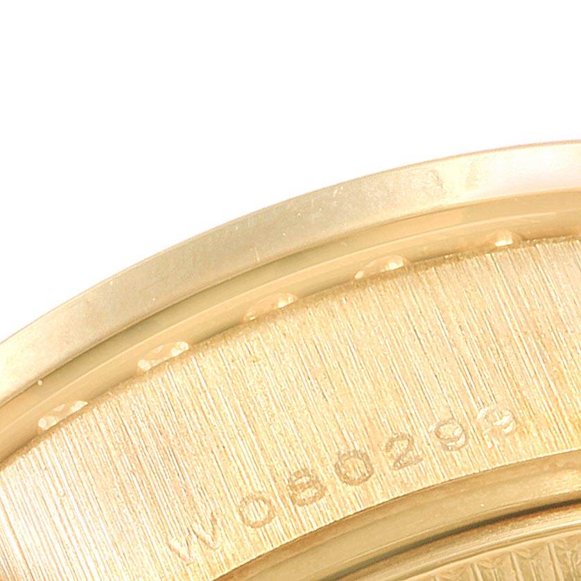 The image shows a close-up view of the edge and back of the Rolex President 69138 Women's Yellow Gold Mother of Pearl Dial 69138 Women's Yellow Gold Mother of Pearl Dial model watch, featuring part of the serial number.