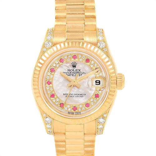 The image shows a frontal view of a Rolex President 179238 Women's Yellow Gold Mother of Pearl Dial 179238 Women's Yellow Gold Mother of Pearl Dial model, featuring its gold band, diamond and ruby markers, and the date window at 3 o'clock.