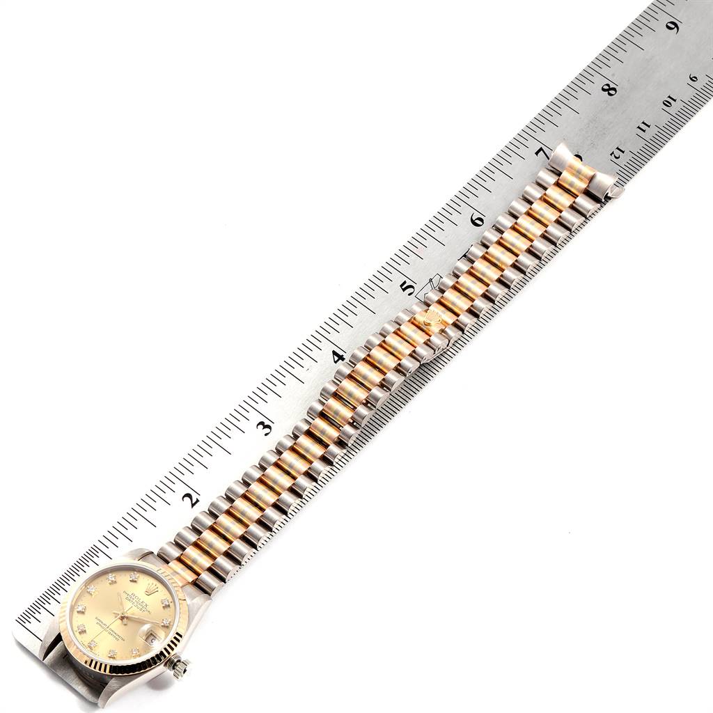 The image shows the full length of the Rolex President 68279 Women's White Gold Champagne Dial 68279 Women's White Gold Champagne Dial watch, including its face and bracelet, aligned next to a ruler.