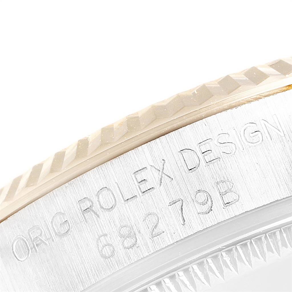 This close-up image shows the edge and part of the case back of a Rolex President 68279 Women's White Gold Champagne Dial 68279 Women's White Gold Champagne Dial model, highlighting the engraved branding and serial number.