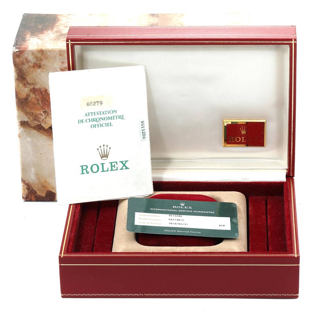 The image shows accessories for the Rolex President 68279 Women's White Gold Champagne Dial 68279 Women's White Gold Champagne Dial model, including certificates and a service guarantee, inside an open box.