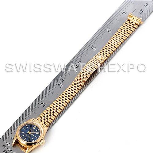 The image shows a Rolex President 67188 Women's Yellow Gold Blue Dial 67188 Women's Yellow Gold Blue Dial model watch laid flat beside a ruler, displaying the watch face, bezel, and full bracelet.