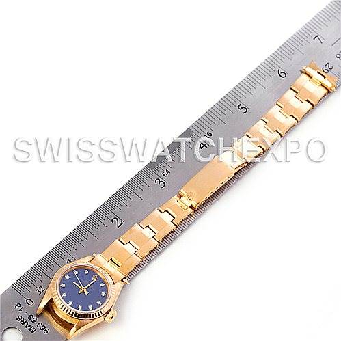 The image shows a Rolex President 67198 Women's Yellow Gold Blue Dial 67198 Women's Yellow Gold Blue Dial model watch with a blue dial and gold bracelet laid next to a ruler for scale.