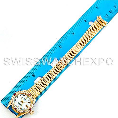 The image shows a Rolex President 69068 Women's Yellow Gold Mother of Pearl Dial 69068 Women's Yellow Gold Mother of Pearl Dial model watch laid flat, highlighting the face, bezel, and bracelet next to a blue ruler for scale.
