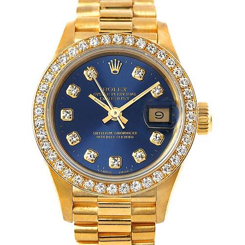 The image shows a Rolex President 69138 Women's Yellow Gold Blue Dial 69138 Women's Yellow Gold Blue Dial model watch from a front angle, highlighting its gold band, blue dial with diamond markers, and diamond-encrusted bezel.
