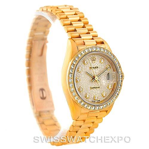 The Rolex President 69138 Women's Yellow Gold Beige Dial 69138 Women's Yellow Gold Beige Dial model watch is photographed at an oblique angle showing the face, bezel, and part of the bracelet.