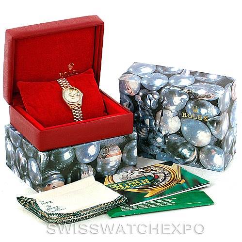 This image shows a Rolex President 69138 Women's Yellow Gold Beige Dial 69138 Women's Yellow Gold Beige Dial model watch in its red box along with its outer packaging, booklets, and cleaning cloth.