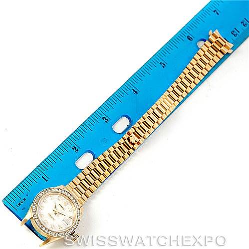 The image shows a Rolex President 69138 Women's Yellow Gold Beige Dial 69138 Women's Yellow Gold Beige Dial model watch lying flat, highlighting its dial, bezel, and bracelet, with a ruler for scale.