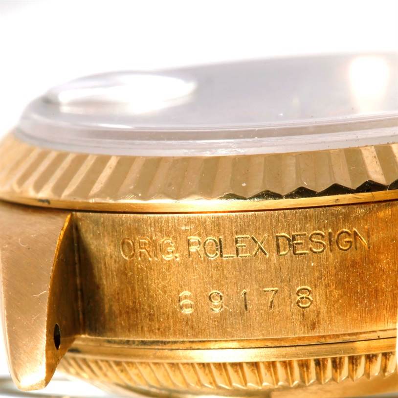 This close-up image shows the side of a Rolex President 69178 Women's Yellow Gold Beige Dial 69178 Women's Yellow Gold Beige Dial model watch, highlighting the engraved design and model number.