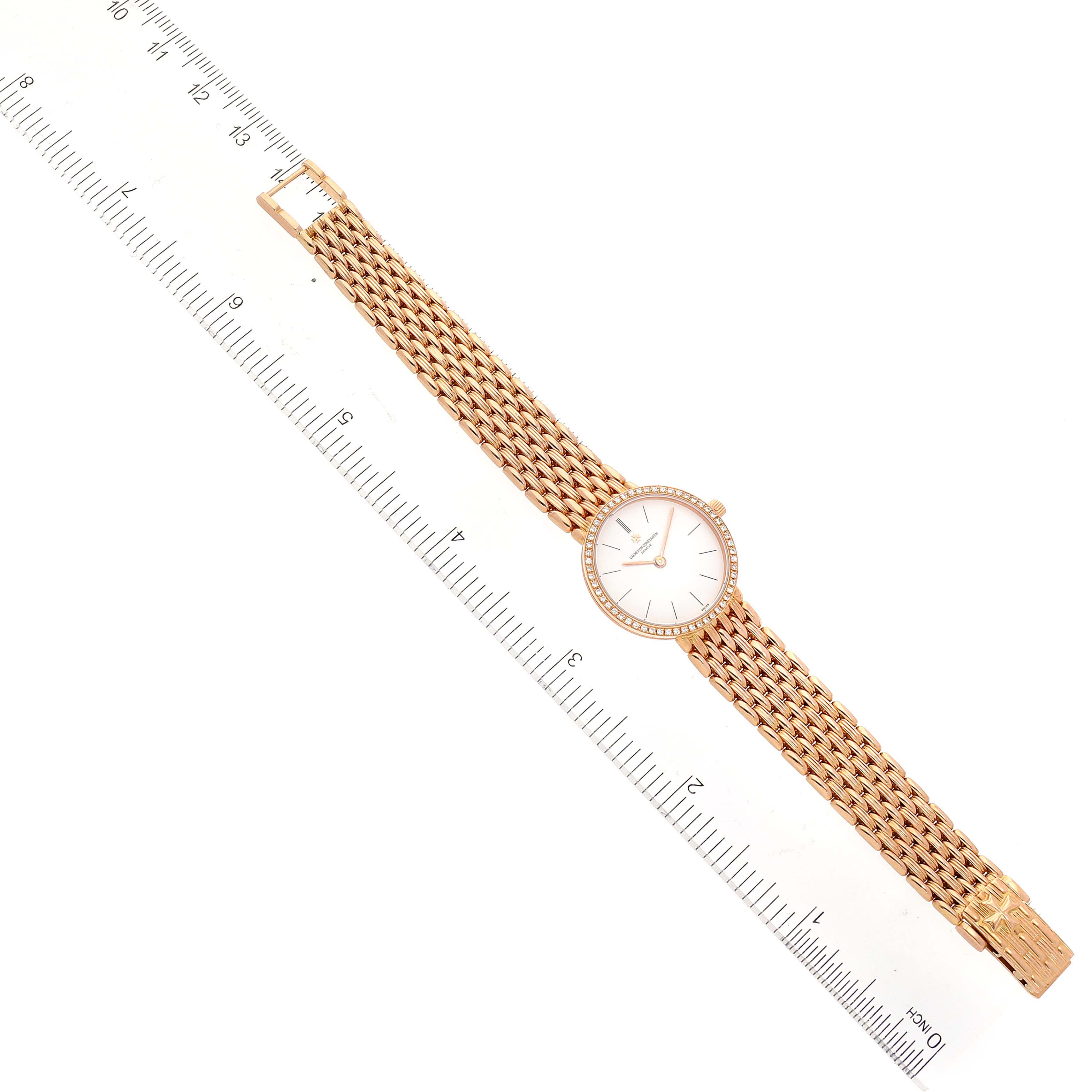 The Vacheron Constantin Traditionnelle 27593 Women's Rose Gold White Dial 27593 Women's Rose Gold White Dial watch is displayed from a top-down angle, showing the entire watch alongside a ruler.