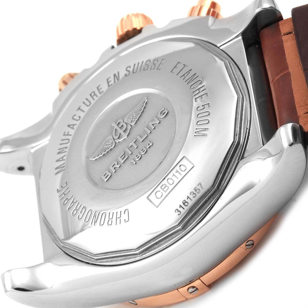 The image shows the back case and part of the strap and crown of a Breitling Chronomat CB0110 Men's Steel and Gold (two tone) Brown Dial CB0110 Men's Steel and Gold (two tone) Brown Dial watch.