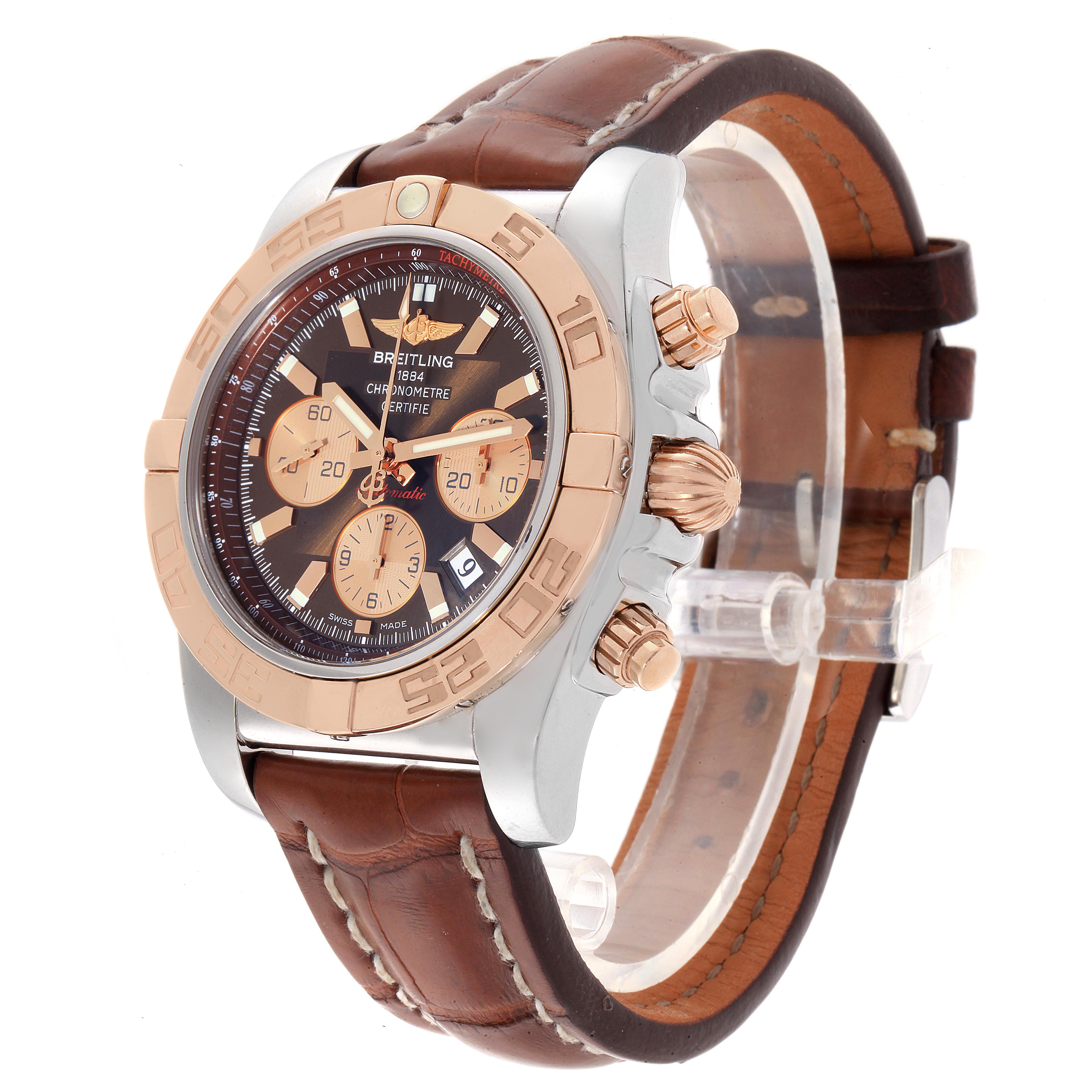 The image shows a side and front angle of a Breitling Chronomat CB0110 Men's Steel and Gold (two tone) Brown Dial CB0110 Men's Steel and Gold (two tone) Brown Dial watch with a leather strap and metal case.