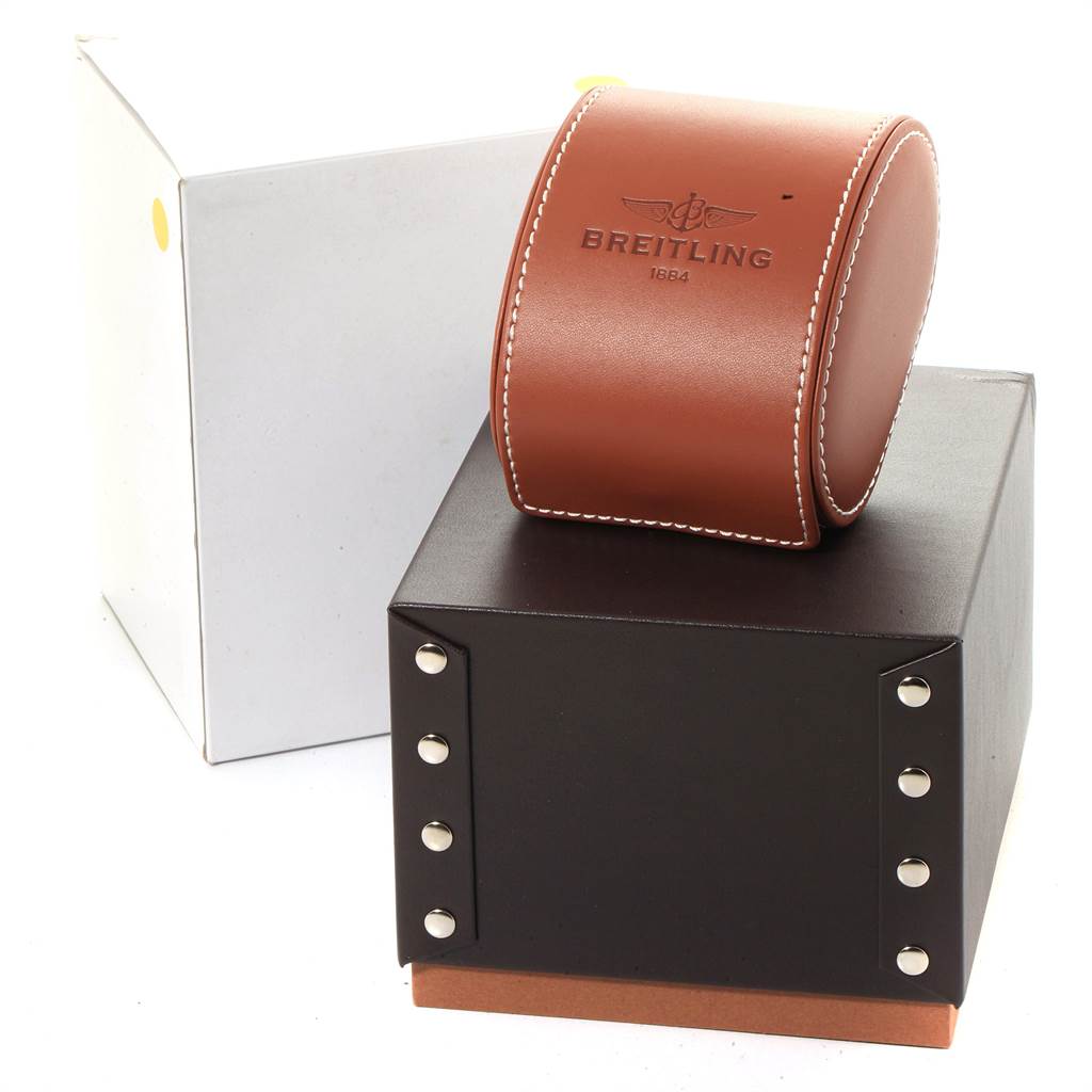 This image shows the packaging for a Breitling Chronomat CB0110 Men's Steel and Gold (two tone) Brown Dial CB0110 Men's Steel and Gold (two tone) Brown Dial watch, including a brown leather case and a sturdy black box with rivets.