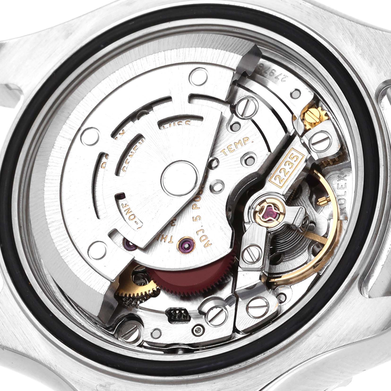 The image shows a close-up view of the Yacht-Master Rolex's internal movement, including gears, screws, and the rotor.